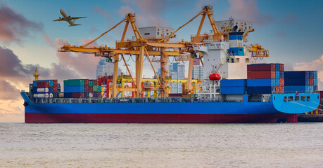 Panorama image of container cargo ship with ports crane bridge at harbor and airplane in sunrise sky. logistics and transportation concept