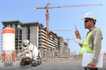 Engineer use radio communication with driver cement mixer truck with precast concrete piles at...