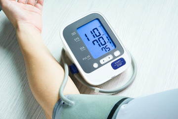 Man check blood pressure monitor and heart rate monitor with digital pressure gauge. Health care and Medical concept