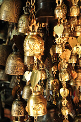 A close-up of golden bells for sale in a market.