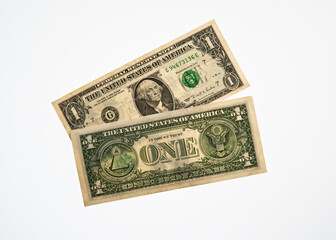   From the obverse and reverse of a one-dollar bill and a one-dollar banknote.
