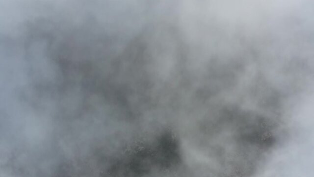 View from above, drone point of view, stunning aerial video of a drone flying over some fluffy moving clouds. Copy space, natural background, video transition.