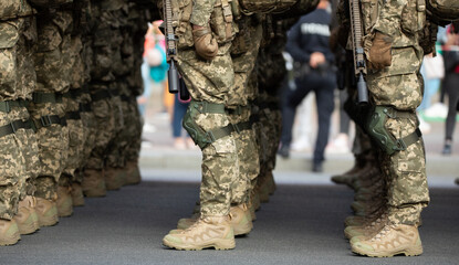 The soldiers' legs are dressed in ankle boots and camouflage pants.