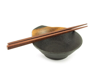Empty old brown clay bowl with stripe and chopsticks isolated on a white background. Japanese...