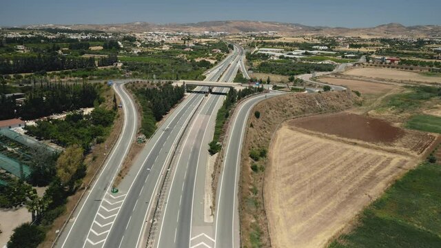Modern highway road cars vehicles drive in wild nature landscape area or suburban region. Speed multi-level motorway with junctions viaducts, automobiles transport traffic. City urban transportation.