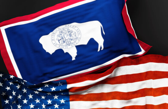 Flag of Wyoming along with a flag of the United States of America as a symbol of a connection between them, 3d illustration