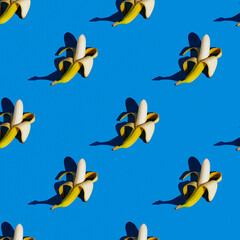 flat seamless pattern of peeled bananas on a blue background