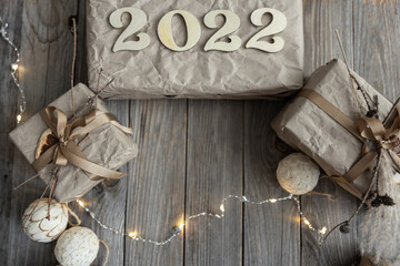 Christmas background with gift boxes and wood numbers 2022, flat lay.