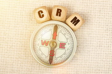 On the table is a compass and cubes with the inscription - CRM