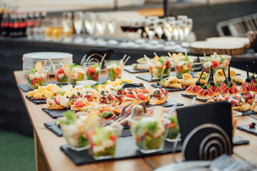 Buffet table of reception with cold snacks, meat and salads