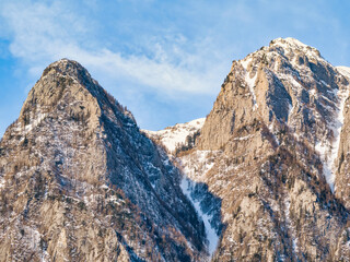 Detail with a pyramid shaped rocky peak covered in snow in the Bucegi Montains, Romania