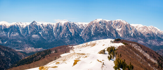 Panoramic view with Bucegi Mountain range covered in snow in Romania. Winter landscape