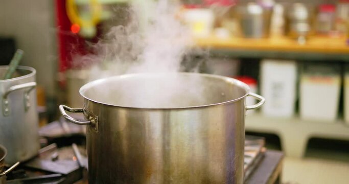 steel pot steaming in a restaurant kitchen 