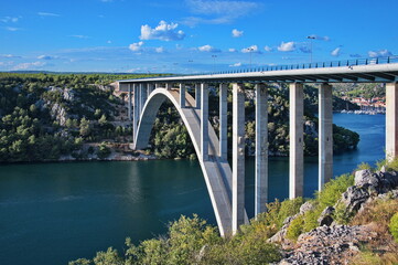 Fototapeta na wymiar Bridge over the deep bay with scenic townscape in the background