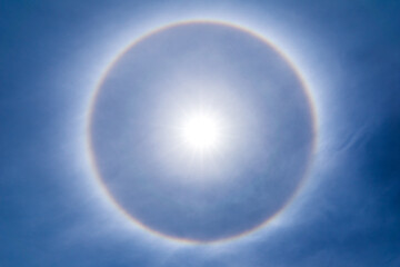 The sun shines brightly in the sky and natural phenomenon called circumscribed halo - obrazy, fototapety, plakaty