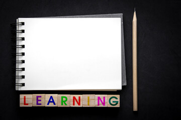 learning concept education and self-development. Wooden blocks with words learning on a black background. for business and education design