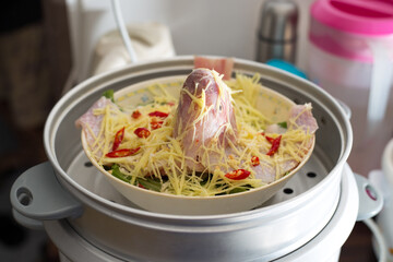 Fresh tilapia fish with ginger and red chili ready to be steamed at home. Healthy eating habit of fresh fish steam with vegetables and ginger. 