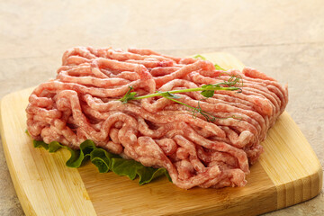 Raw minced pork meat over board