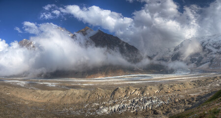 A panoramic image of mountains covered with clouds.