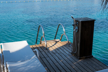 empty sunbeds on the sea shore, top view