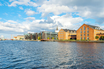 Beautiful modern buildings on the bank of the canal in Copenhagen, Denmark.Sun, beautiful clouds....