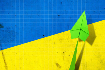 Upward arrow on the background of the flag of Ukraine. Paper plane. Economic recovery. Copy space. Business.