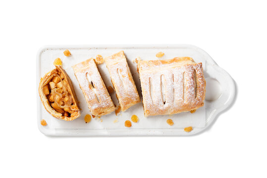Traditional homemade apple strudel with caramelized apples and raisins. isolated on white background. top view