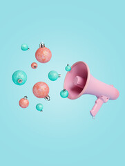 Pink megaphone speaker with green and pastel pink Christmas tree ornament on pastel blue background. Announcement of winter holiday season. Creative Christmas or New Year festive concept.