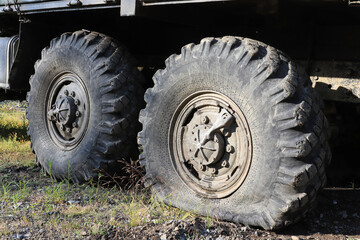 Fototapeta na wymiar A flat tire of the off-road vehicle Ural-4320, closeup
