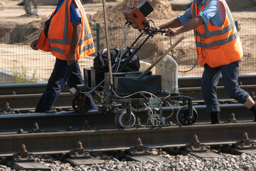 Railway workers check the condition of the rails with a flaw detector.