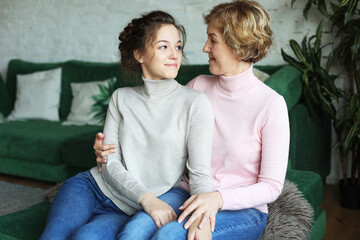 lifestyle, family and people concept: Happy young woman and her mother at home