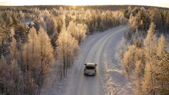 car driving on rural offroad in wild winter forest destination explore environment on trip, aerial view of wood on north and auto with equipment for extreme path and locations
