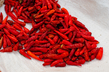 Naklejka premium Close-up of red chili peppers drying in the sun in a basket