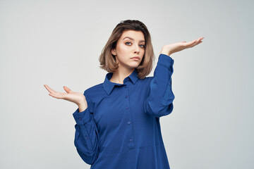 Business woman in blue shirt emotions posing light background