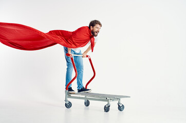 Fototapeta premium Cheerful man ride a cart entertainment light background