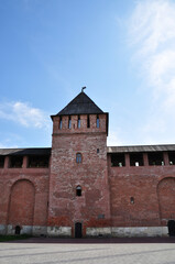 View of the old fortress wall with a tower. Fortress wall with a wooden roof.