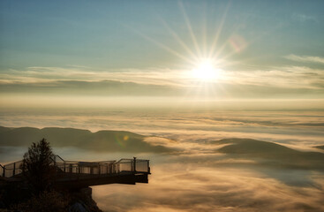Sunrise in the alps over clouds and fog with skywalk
