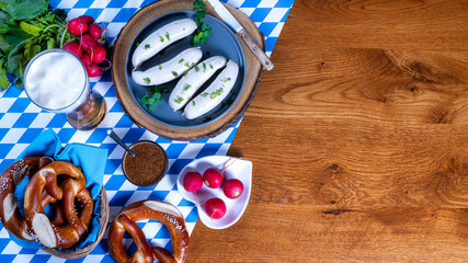 Bavarian sausages with pretzels, sweet mustard, radish and beer on a rustic wooden table. Oktoberfest menu, top view, copy space.