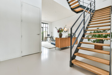Designed in a minimalistic style staircase hall. Interior of luxury house stairs