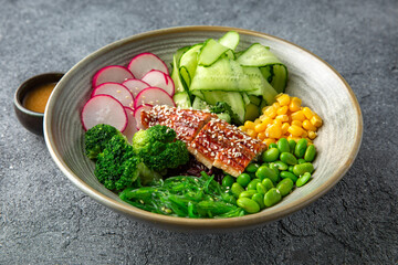 Buddha bowl with smoked eel, green beans, broccoli, corn. Diet healthy nutritious food. Ready menu for the restaurant. Neutral gray blue textured background