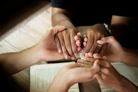 Christians are congregants join hands to pray and seek the blessings of God. Devotional or prayer meeting concept.
