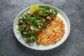Grilled octopus salad, avocado, tomatoes, sweet peppers. Ready menu for the restaurant. Neutral gray blue textured background