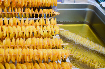 Street food. Cooking potato chips