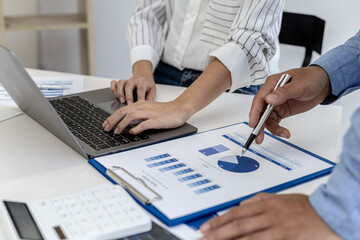 Fototapeta premium The sales department is having a monthly summary meeting to bring it to the department manager, they are verifying the correctness of the documents that are prepared before bringing in to the manager