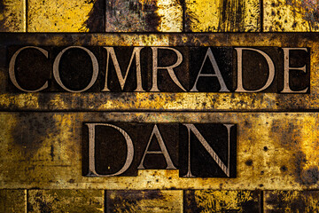 Comrade Dan text on textured grunge copper and vintage gold background