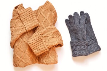 Trendy brown color woolen sweater and knitted gray gloves. Fall and winter women's clothes flat lay photo