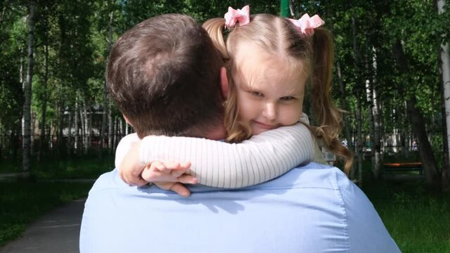 strong Father holds on his arms a sweet daughter, 3 years old, hugs her and hugs her. The concept of parenting, overcoming problems in the relationship between father and daughter, illness, fear for