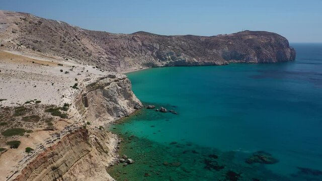 Aerial drone video of volcanic island bay with Perlite rock and emerald crystal clear sea in tropical exotic destination