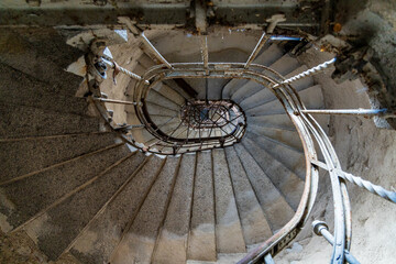 Gray spiral concrete staircase in old high building