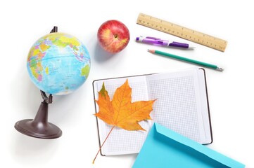 Globe, open notebook, pen, pencil, ruler, red apple on the school desk. Flat lay education concept photography. International Teachers Day - Powered by Adobe
